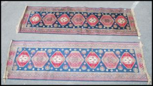 A pair of Persian 20th century silk runners / rugs having blue grounds each with central runs of