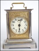 A vintage 20th century German silver white metal carriage clock having handle to top. Measures 15cms