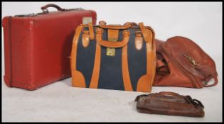 A vintage retro 20th century suitcase in red along with a vintage Gladstone bad, a leather holdall