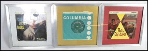 Three framed and glazed 1960s 45rpm vinyl records, Cliff Richard and The Drifters Living Doll, The