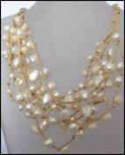 A vintage multi strand baroque pearl necklace consisting of many strands of pearls with a claw