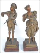 A pair of 20th century after J Lavergne spelter figurines of a lady and gent raised on plinth