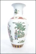 A large 18th /19th century Chinese Kangxi vase of baluster form decorated with famille rose patterns