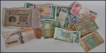 A collection of bank notes to include Banco De Mocambique, Half Dinar Kuwait, 10000 Lire, Belgian