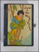 A vintage Jack and the Beanstalk money tin in the form of a book with lock and key to side.