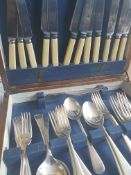 A 20th century oak cased canteen of cutlery having a blue fitted interior.