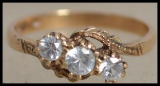 A hallmarked 9ct gold crossover trilogy ring, set