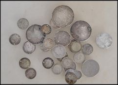 A collection of silver coins dating from the 19th century to include threepence coins, six pence,