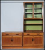 A G-Plan 20th century teak wood set of modular upright wall cabinets. The sectional body with fall