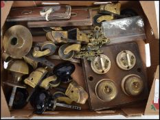 A mixed lot of architectural fittings, industrial brass switches, door knobs, handles and castors