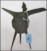 An Oriental bronze pourer / censor ding raised on