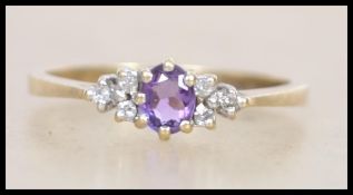 A hallmarked 9ct gold ring set with a central oval