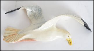 A Beswick wall hanging plaque in the form of a large flying Seagull stamped to rear Beswick 658/1.