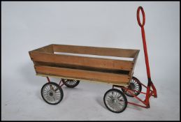 A vintage wooden childs trolley cart. With wooden