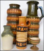 A collection of various West German fat lava ceramic vases and stick stands of various sizes.