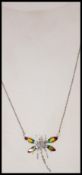 A ladies Art Nouveau silver and plique a jour dragon fly pendant complete with the necklace in