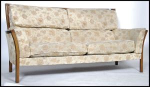 A contemporary Ercol three seater sofa / settee having a chintzy fabric upholstery  ( Fabric No E015