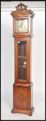 An antique style longcase - grandfather clock with decorative dial in mahogany case, the dial marked