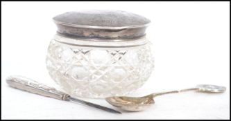 A mixed lot of mostly silver hallmarked items to include a manicure tool, a cut glass dressing table