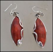 A pair of ladies silver and apple coral earrings of contemporary form being complete in the original