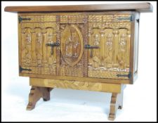 A continental 20th century hardwood Spanish armada style cabinet sideboard having profusely carved