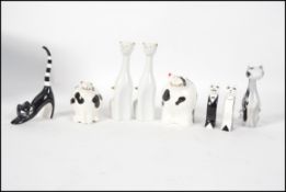 A collection of cat figurines, all of modern ceramic design to include a pair of Villeroy & Boch