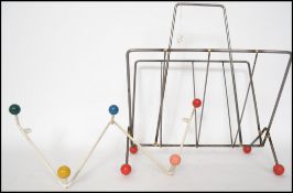A vintage retro sputnik atomic set of coat hooks in a painted white finish with multi coloured
