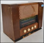 A vintage 20th century 1940's wooden cased valve radio. The glass dial to the front marked for