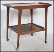 A 1970's Danish influence Remploy teak wood butlers trolley being raised on angular legs with