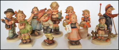 A large collection of vintage Goebel West German Hummel figurines to include Skier, Wayside
