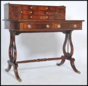 A Regency revival mahogany ladies writing table desk - bonheur de jour being raised on turned legs
