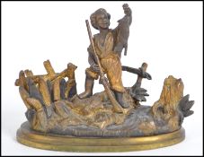 A 19th century gilded bronze matchstrike / match strike in the form of a child hunter with musket
