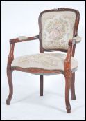 A 20th century French tapestry upholstered fauteuil armchair. The reeded mahogany frame with