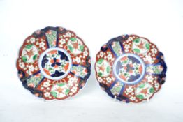 A pair of 20th century Chinese Imari pattern dishes in poly-chrome colours of red, blue and white
