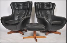 A good pair of  1970's retro egg shaped faux black leather swivel armchairs together with the