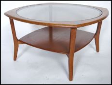 A vintage retro 20th century atomic teak wood hex topped  coffee table, drop in glass top with lower