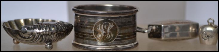 A group of sterling silver items to include a silver hallmarked napkin ring, a silver salt in the