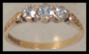 A hallmarked 9ct gold trilogy ring set with three