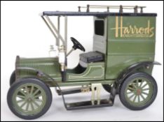 A vintage style tinplate large scale Harrods Ford van in traditional green colourway with Harrods