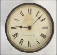 A early 20th century bulk head clock having a Roman Numeral chapter ring with faceted hands and