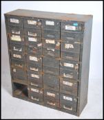 An Industrial mid century metal filing cabinet having 20 drawers ( one missing ) in remains of