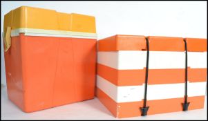 A vintage retro 1960s stacking plastic picnic boxes having 4 orange and white stacking trays and