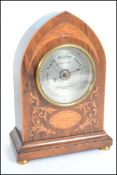 A 19th century Art Nouvaeu cased lancet shaped mantle barometer with inlaid marquetry work raised on