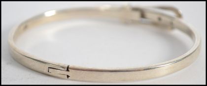 A ladies 20th century silver bangle in the form of a belt ( see illustrations ) Measures 6cms wide