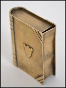 A vintage early 20th century believed trench art vesta / lighter in the form of a book having hidden