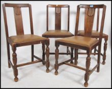 A set of4 1930's Art Deco oak dining chairs raised on cup and cover legs united by stretchers having