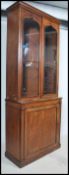 A Regency 19th century mahogany library bookcase cabinet having a twin door cupboard cabinet under a