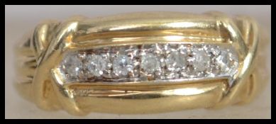 A hallmarked 9ct gold and diamond  band ring with 7 illusion set diamonds and kiss cross