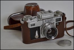 A vintage 20th century Russian made cased Kiev Rangefinder Camera, together with a Zeiss - Opton f -