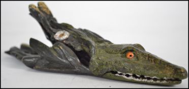 A 20th century cold painted bronze paperclip in the form of a crocodile and all in the manner of